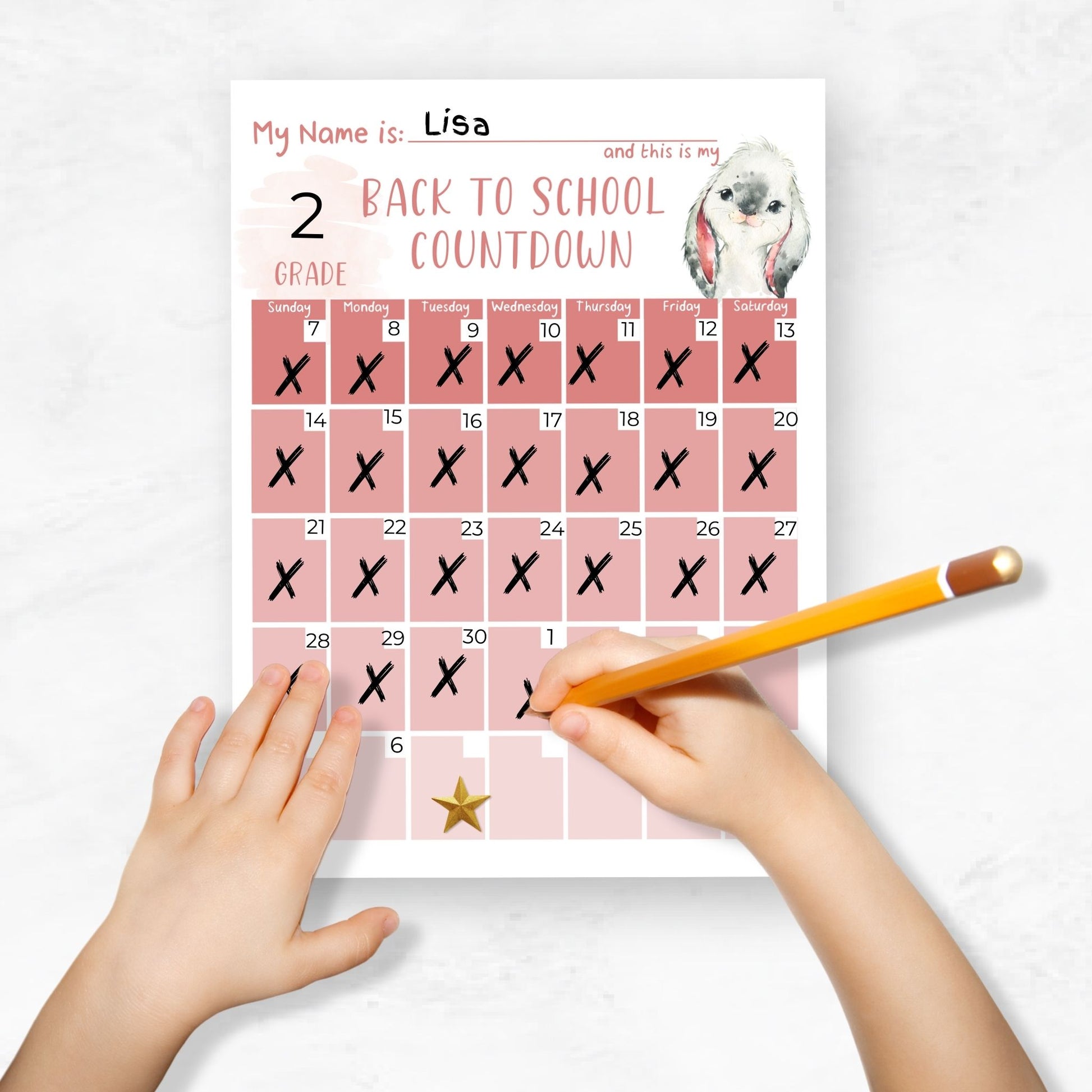 mockup image of a childs hands holding a pencil. Child is filling in a countdown printable calendar for back to school with pink ombre designs and a watercolor bunny 